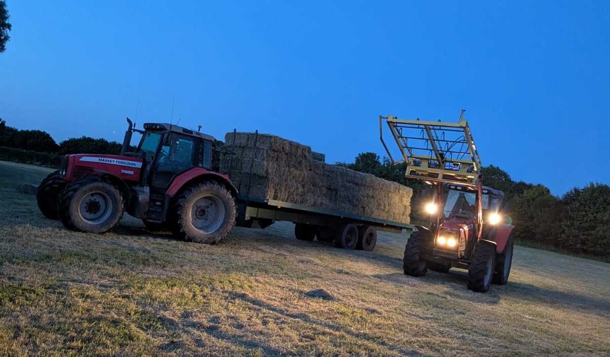 loading hay bales in the evening